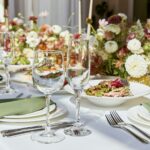 Aesthetic table setting with candles and flowers decorations. Restaurant chamber event