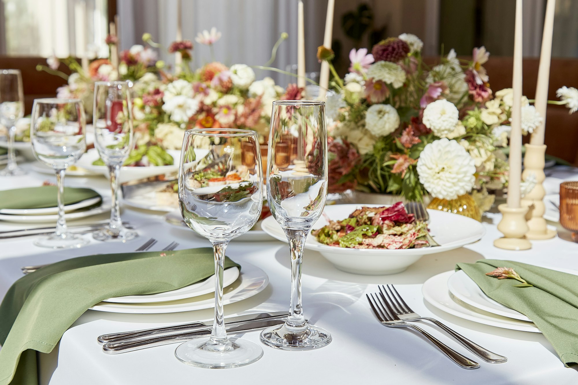 Aesthetic table setting with candles and flowers decorations. Restaurant chamber event